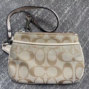 Coach pink and tan wristlet with zipper and pocket